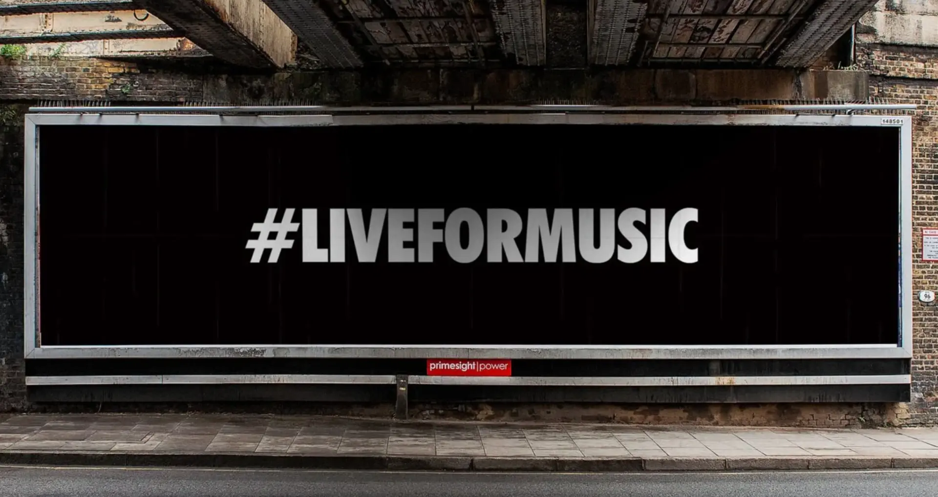 Marshall billboard under a railway arch reading #LIVEFORMUSIC
