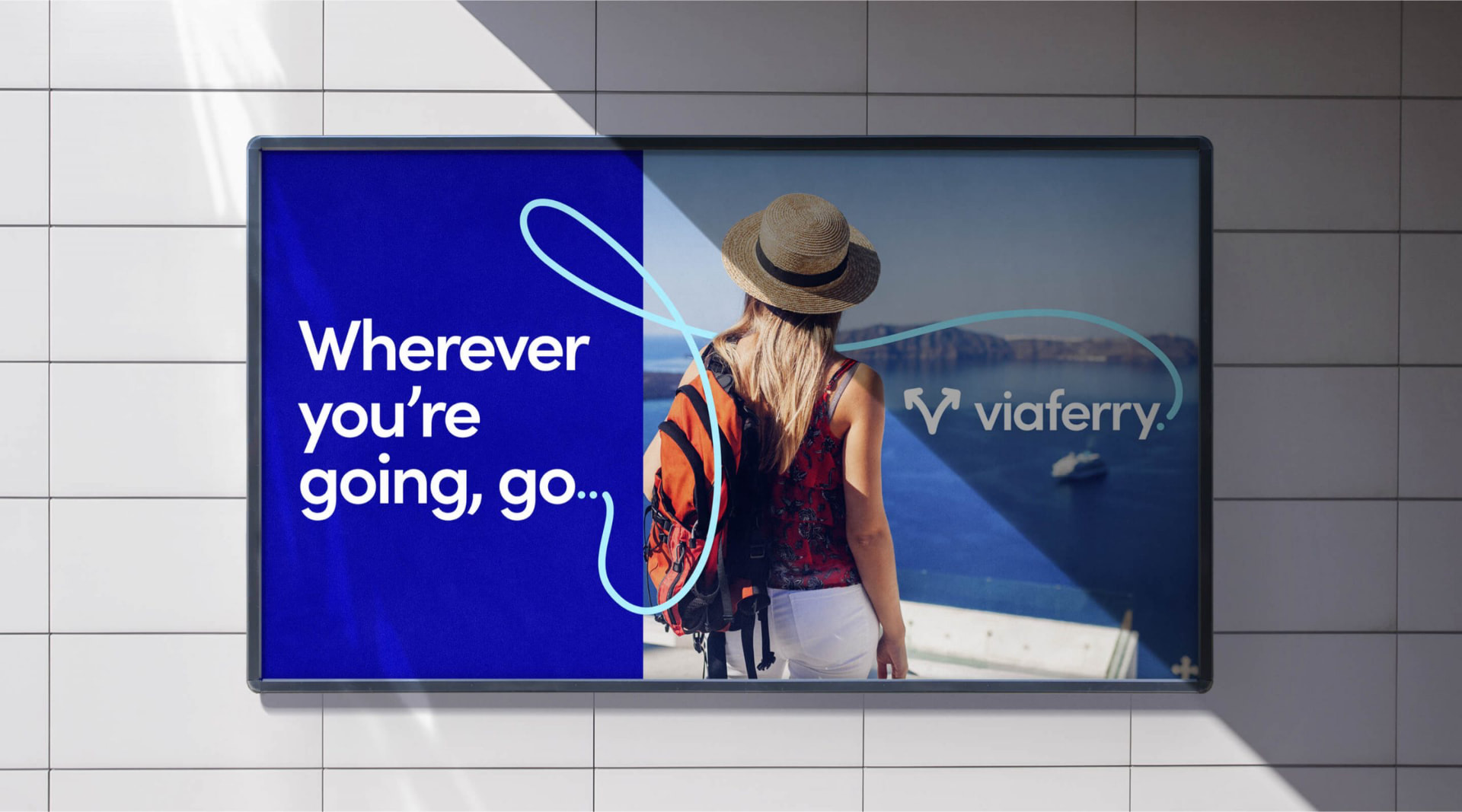 ViaFerry campaign billboard reading Wherever you're going, go ViaFerry, with a traveller looking out over the water